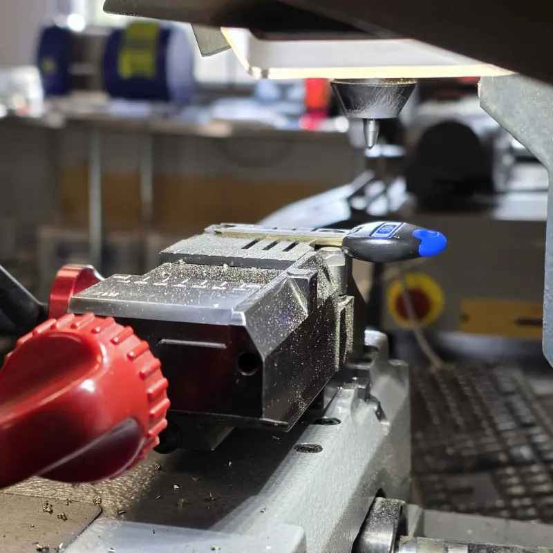 Key held in a Silca cutting machine beneath the cutter